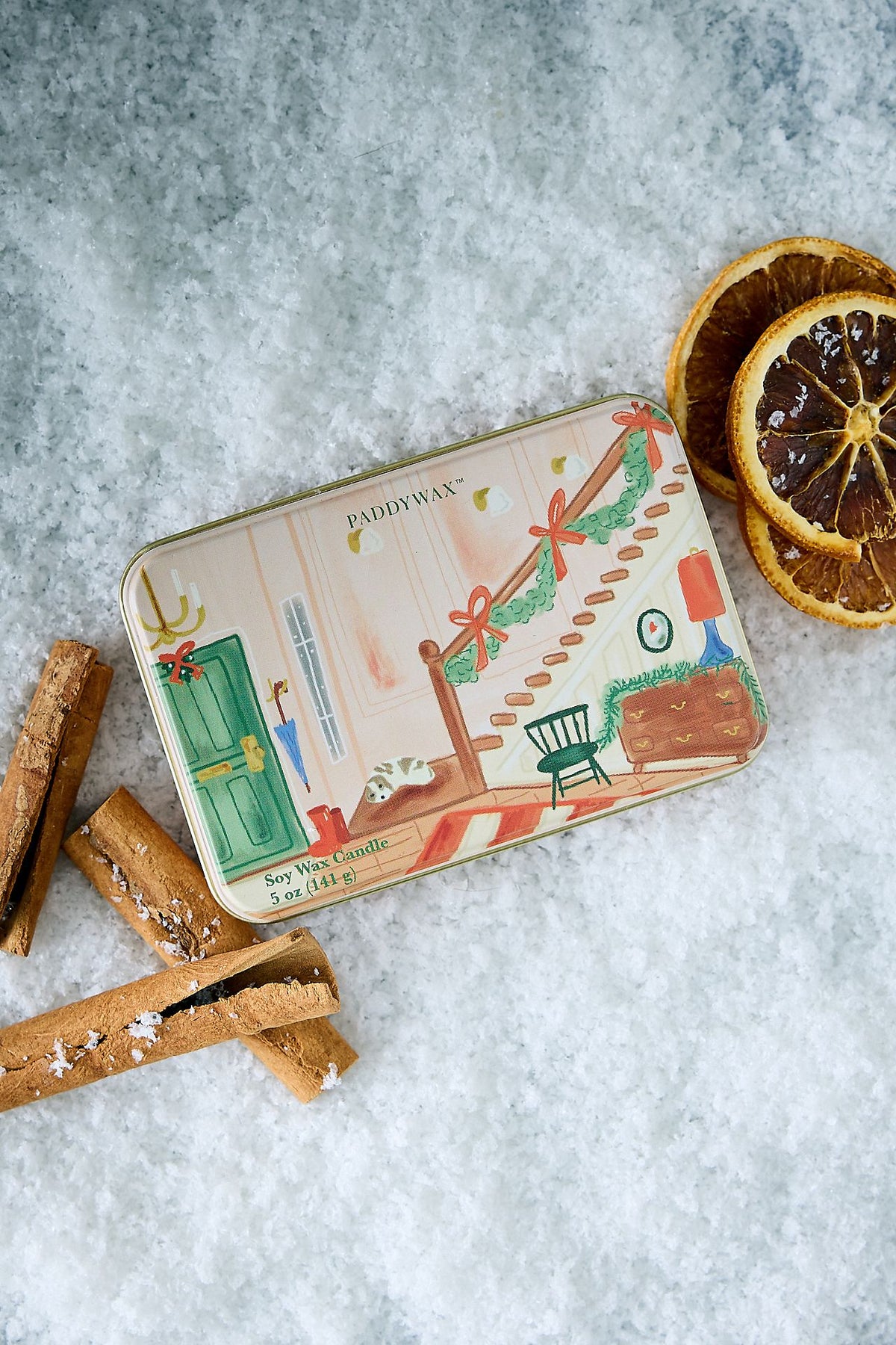 Wassail Holiday Tin Candle with festive staircase scene