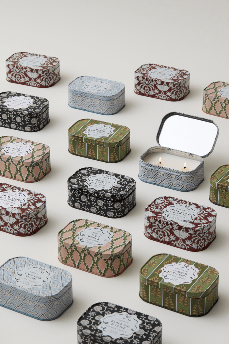 Chérie tin candles arranged with an open Yuzu Woods tin