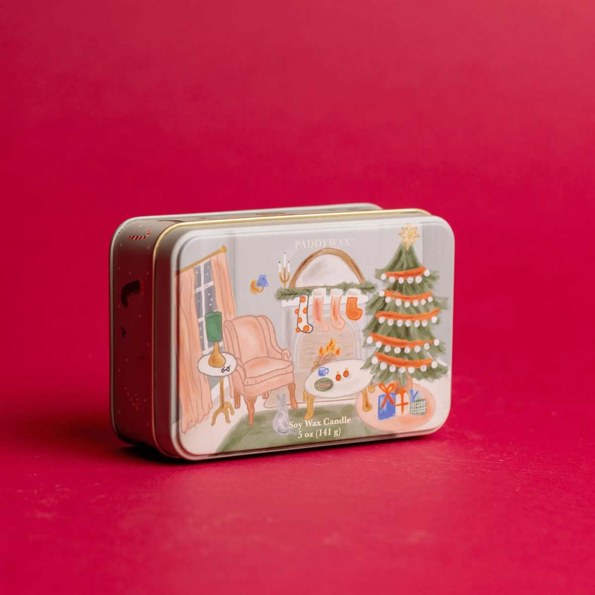 Persimmon & Chestnut Holiday Tin Candle on red background